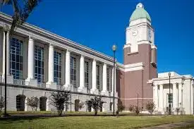 Historic courthouse building with clock tower and columns