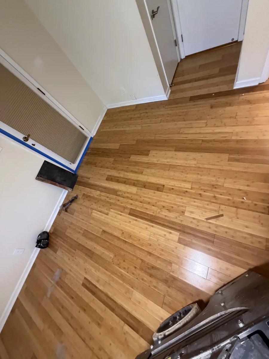 Before: glued-down wood floor in the same room