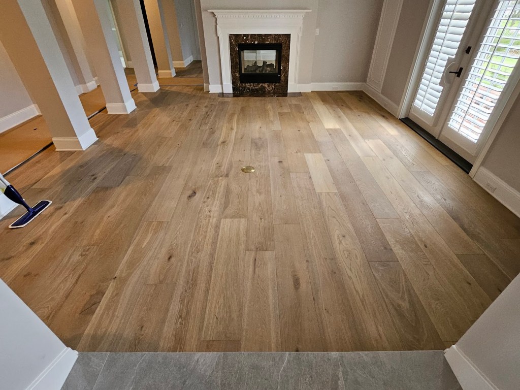 Wide-plank oak flooring installed in a North Jacksonville living room by Advanced Flooring Removal