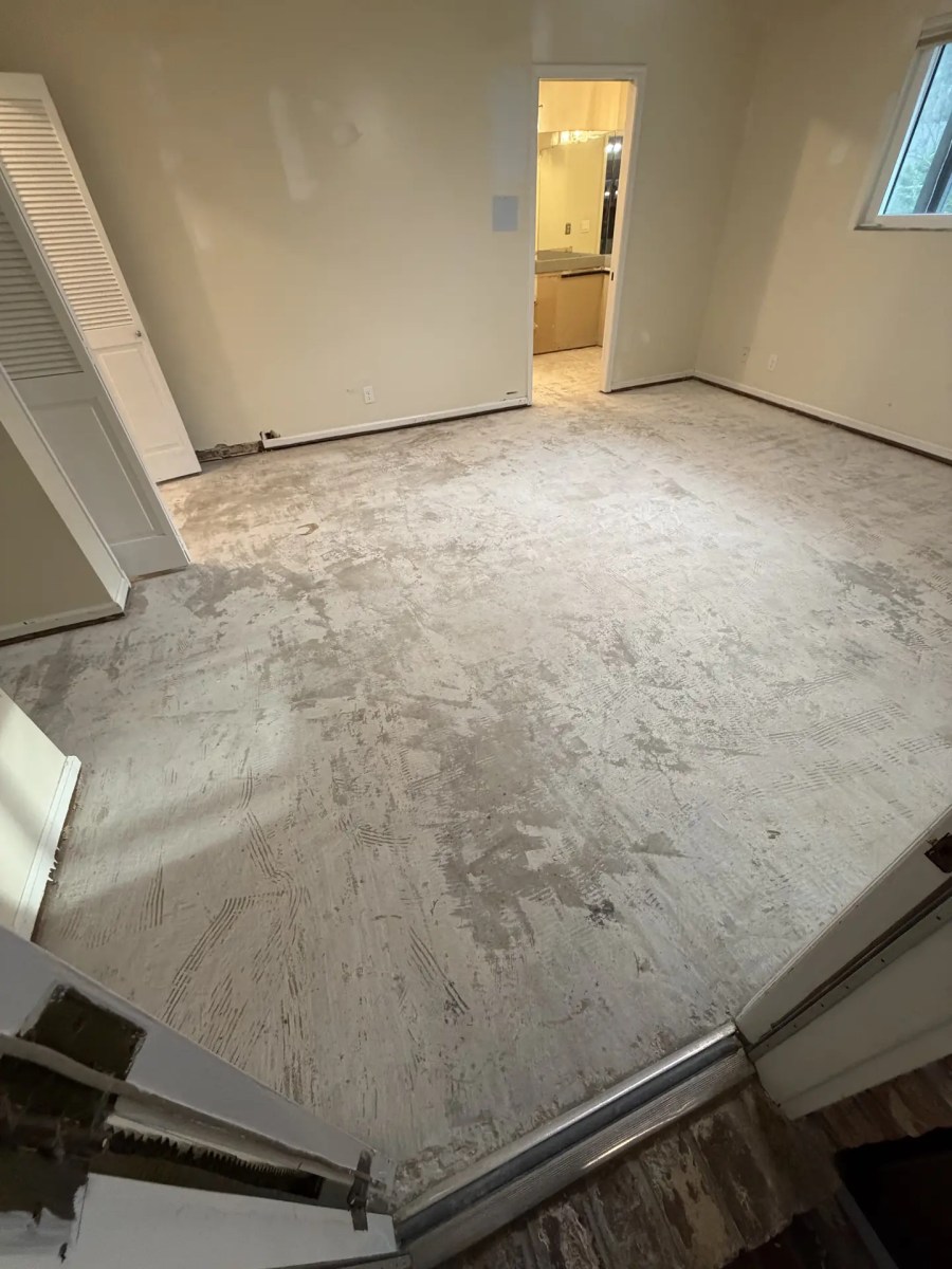 After: the same room with the wood floor and adhesive removed down to the slab
